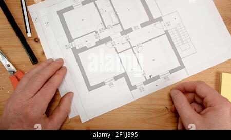 Top view, interior designer hand simulates the walls of a house plant, ideal for topics such as buil Stock Photo