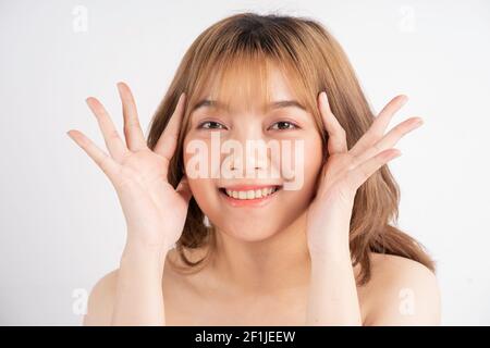 Beautiful xing woman with fresh skin smiling on background Stock Photo