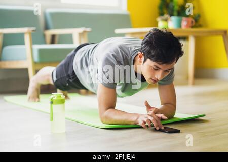 Asian man doing exercise at home Stock Photo