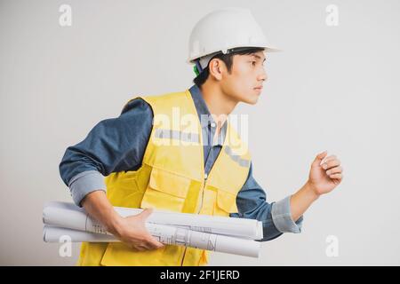 Asian construction engineer portrait holding the running drawing Stock Photo