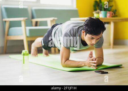 Asian man doing exercise at home Stock Photo