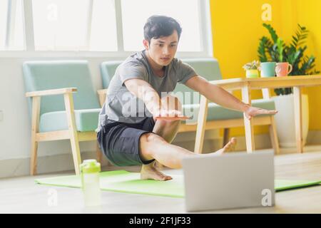 Asian man doing exercise at home Stock Photo