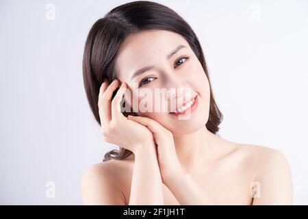 Beautiful xing woman with fresh skin smiling on background Stock Photo