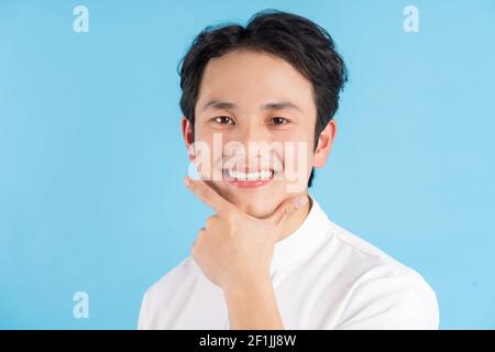 Portrait of young man smiling and looking at camera Stock Photo
