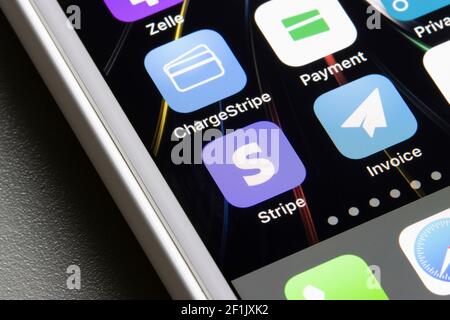 Stripe Dashboard app and three of the various Stripe partner apps - ChargeStripe, Stripe for Payment, Invoice for Stripe - are seen on an iPhone. Stock Photo