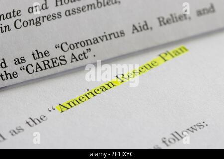 Closeup of the documents of both the Cares Act (Coronavirus Aid, Relief, and Economic Security Act) and the American Rescue Plan Act of 2021. Stock Photo