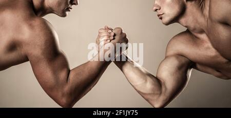 Two hands. Muscular men measuring forces, arms. Hand wrestling, compete. Hands or arms of man. Muscular hand. Clasped arm wrestling Stock Photo
