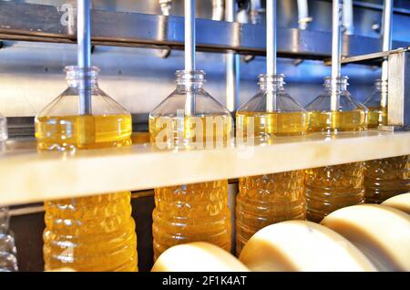 Sunflower oil. Factory line of production and filling of refined oil from sunflower seeds. Factory conveyor of food industry Stock Photo