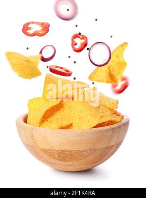 Flying nachos with ingredients and bowl on white background Stock Photo