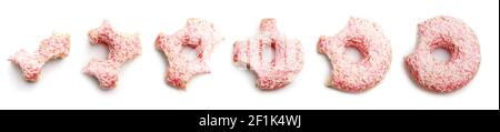 Process of eating tasty donut on white background Stock Photo