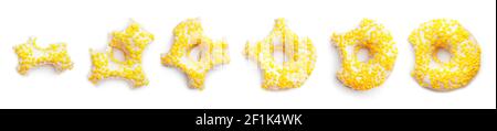 Process of eating tasty donut on white background Stock Photo