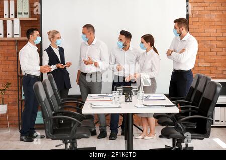 Business people having meeting in office during coronavirus epidemic Stock Photo
