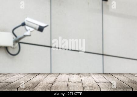 empty wooden table with cctv camera. Stock Photo