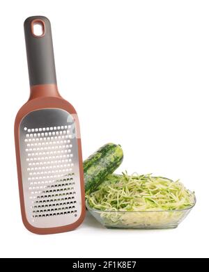 Metal grater and zucchini on white background Stock Photo