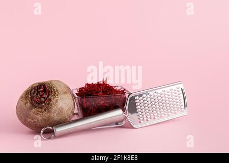 Metal grater and fresh beetroot on color background Stock Photo