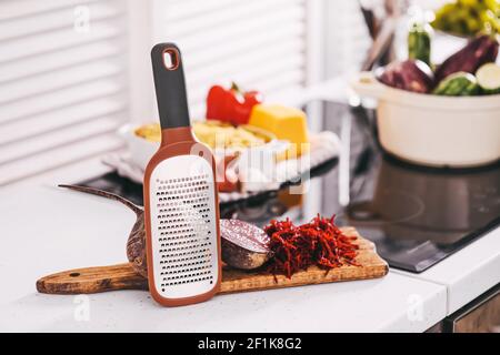 Fresh beetroot and grater on kitchen table Stock Photo