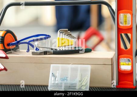 Rack with construction tools in workshop Stock Photo