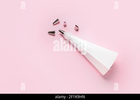 Pastry bag and different tips on color background Stock Photo