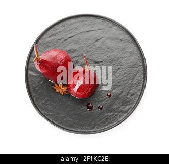 Plate with sweet poached pears in red wine on white background Stock Photo