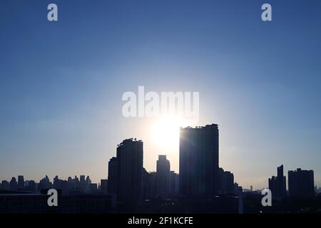 Stunning Sunset Ray Shining Through the Skyscrapers Stock Photo