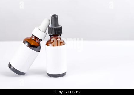 Two mockup bottles with pipettes on a white background Stock Photo