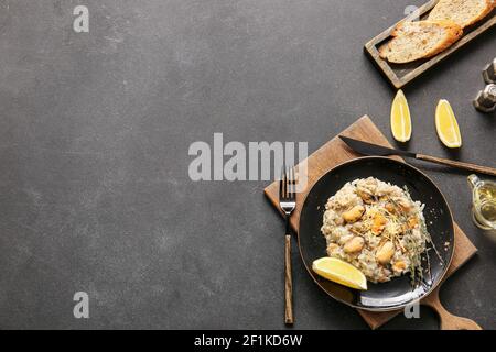 Plate with tasty risotto on dark background Stock Photo