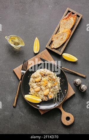 Plate with tasty risotto on dark background Stock Photo