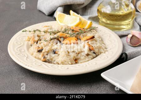 Plate with tasty risotto on dark background Stock Photo