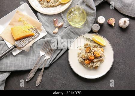 Plate with tasty risotto on dark background Stock Photo