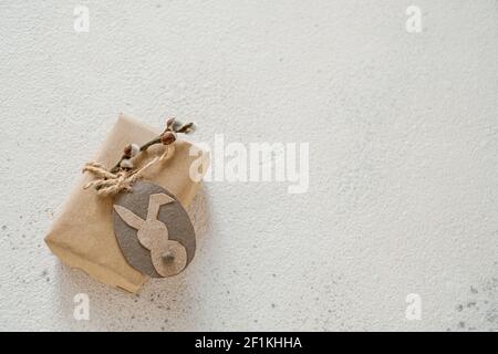Gift box wrapped in kraft paper tied with willow branch, twine decorated with tag. DIY. Zero waste Stock Photo