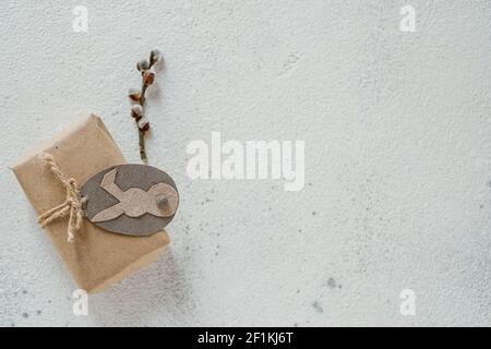 Gift box wrapped in kraft paper tied with willow branch, twine decorated with tag. DIY. Zero waste Stock Photo