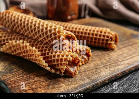 Tasty wafer rolls with boiled condensed milk, closeup Stock Photo