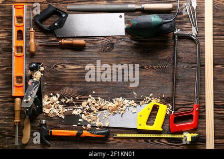 Frame made of carpenter's tools and saw dust on wooden background Stock Photo