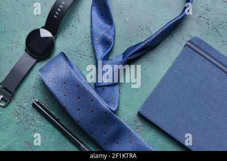 Stylish male accessories and notebook on color background Stock Photo