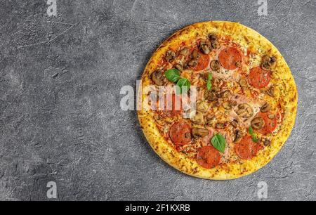 Whole neapolitan pizza served on dark board Stock Photo