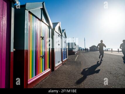 Brighton UK 9th March 2021 - Runners make the most of a beautiful sunny morning along Hove seafront as wet and stormy weather is forecast to arrive in the next few days throughout Britain : Credit Simon Dack / Alamy Live News