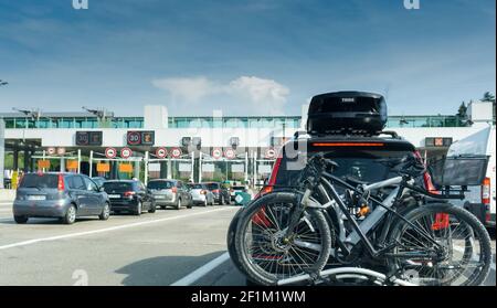 Many cars passing through a toll booth stop in heavy summer holiday traffic on the French highway sy Stock Photo