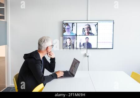 Man in boardroom having video conference Stock Photo