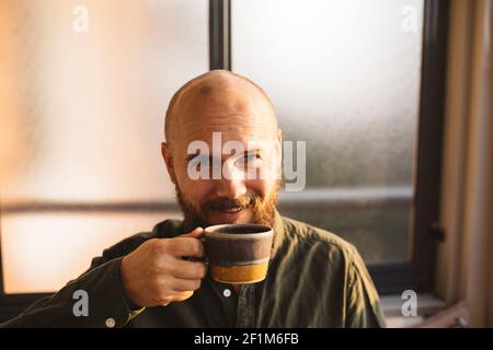 Smiling man drinking coffee Stock Photo