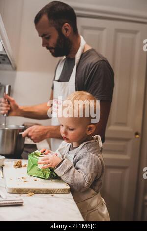 Father and son cooking together Stock Photo