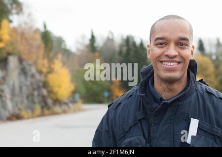 Smiling firefighter looking at camera Stock Photo