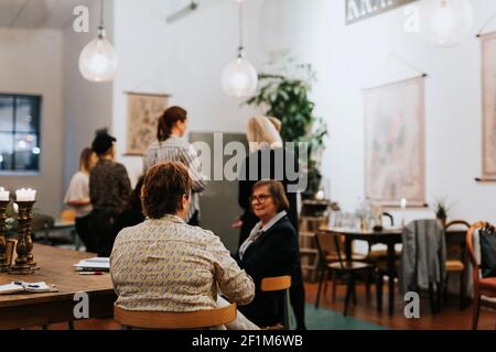 Female coworkers having meeting in cafe Stock Photo