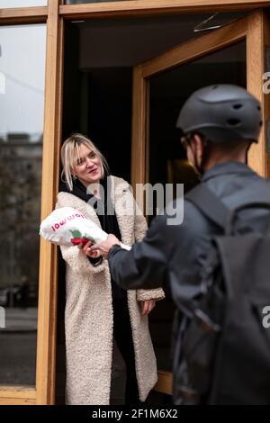 Bicycle courier delivering flowers Stock Photo