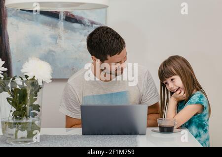 Father and daughter using laptop Stock Photo