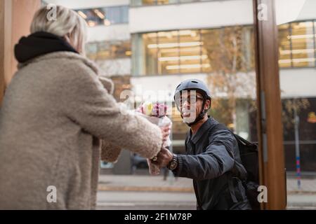 Bicycle courier delivering flowers Stock Photo