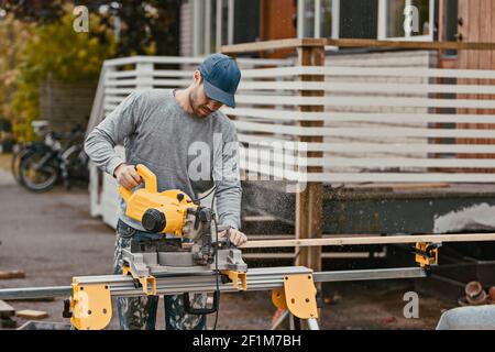 Carpenter using circular saw Stock Photo