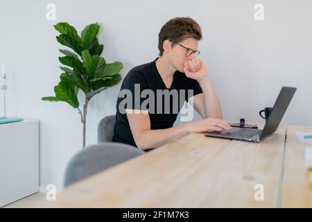 Man using laptop at home Stock Photo