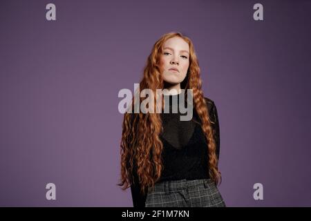 Woman looking at camera, studio shot Stock Photo