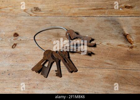 Rusty keys on wooden background Stock Photo