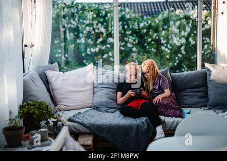 Girl using cell phone together Stock Photo